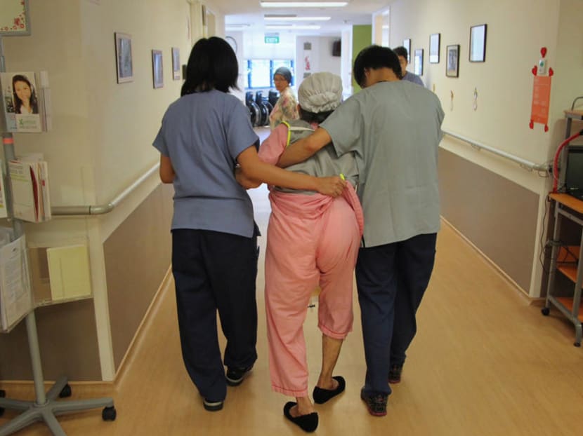 A patient receiving help from nurses at a Dementia Care Ward in a hospital in Singapore. TODAY file photo