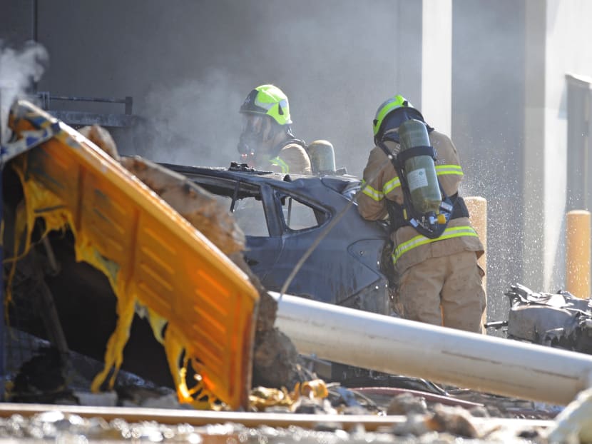 Emergency services personnel are seen at the scene of a plane crash in Essendon in Melbourne on Feb 21, 2017. Photo: AAP via Reuters