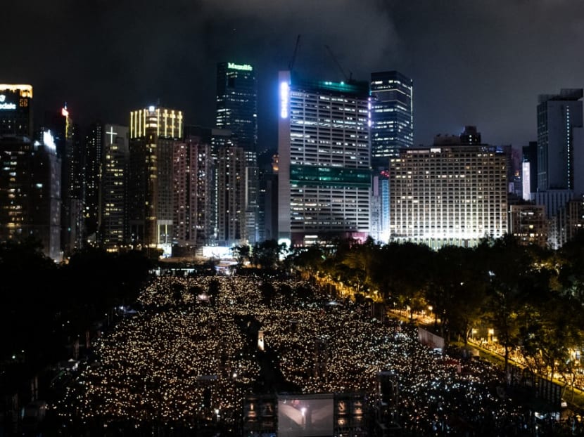 In this file photo taken on June 4, 2019, people attend a candlelight vigil at Victoria Park in Hong Kong to mark the 30th anniversary of the 1989 Tiananmen crackdown in Beijing. Hong Kong police on Sept 8, 2021 arrested multiple members of the group behind the city's Tiananmen Square vigils, a day after their organisation declared they would refuse to cooperate with a national security investigation.