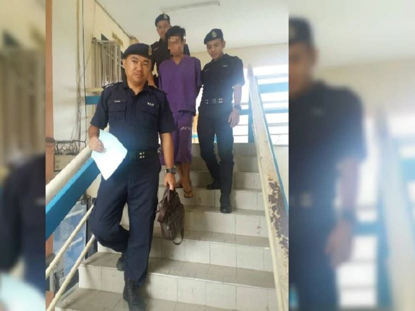 The 26-year-old suspect surrendered to the police after allegedly killing his father. Photo: NEW STRAITS TIMES
