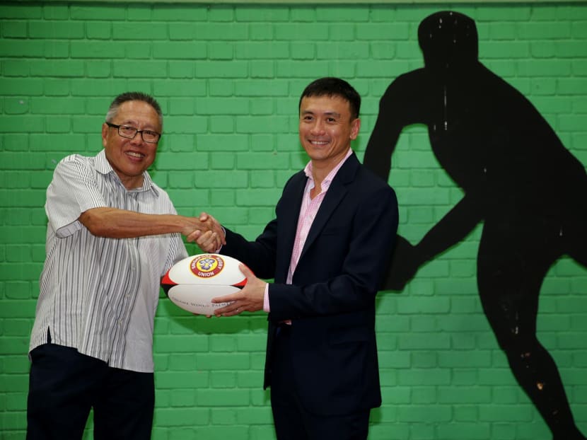 Former Singapore Rugby Union president Low Teo Ping (L) and newly elected Singapore Rugby Union president Terence Khoo (R) posing for a photo after the election on June 20. Photo: Wee Teck Hian/TODAY