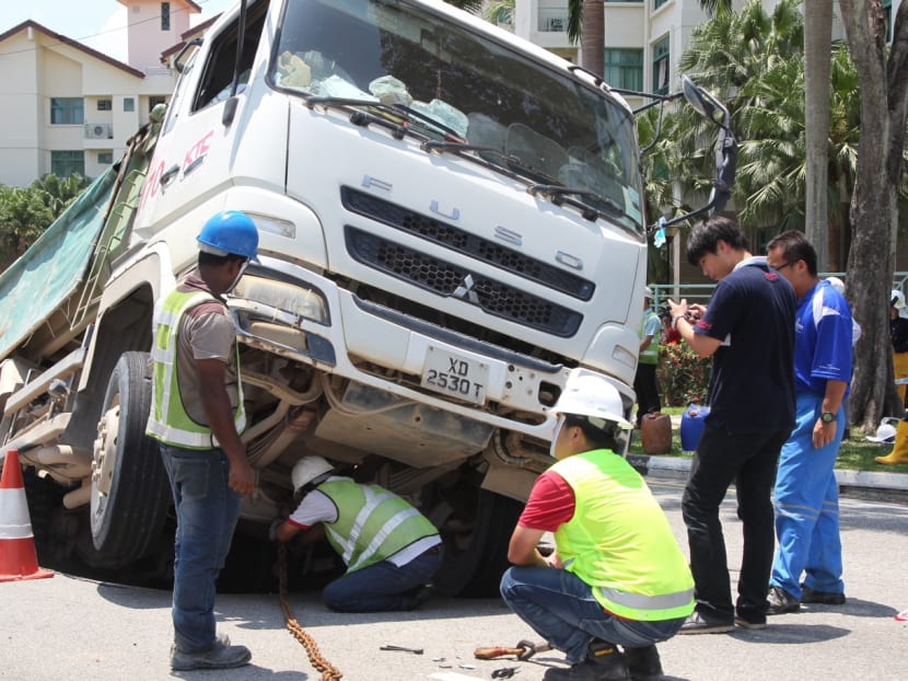 Gallery: Truck sinks into ground along Upper Changi Road East