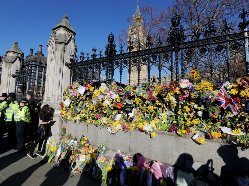 Floral tributes on the wall surrounding the houses of Parliament on Saturday, following the attack in Westminster, in central London, Britain. Photo: Reuters