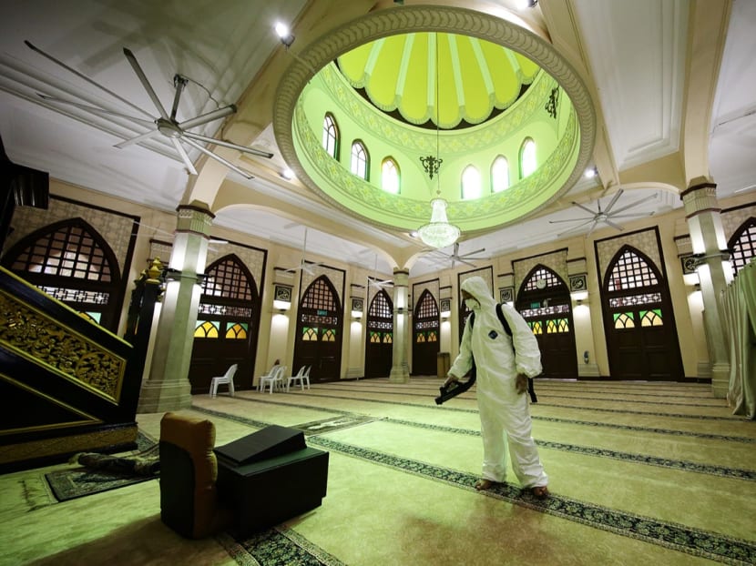 A cleaning professional disinfecting carpets and high contact surfaces at Masjid Hajjah Fatimah.