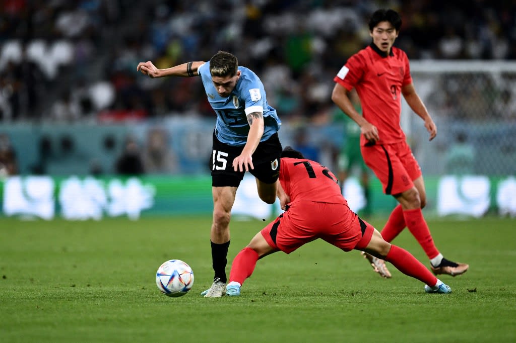 Uruguay's midfielder #15 Federico Valverde fights for the ball with South Korea's midfielder #18 Lee Kang-in during the Qatar 2022 World Cup Group H football match between Uruguay and South Korea at the Education City Stadium in Al-Rayyan, west of Doha on Nov 24, 2022.
