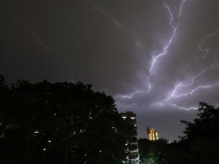 Lightning strikes over residential apartments during a thunderstorm on the outskirts of the Indian capital New Delhi.