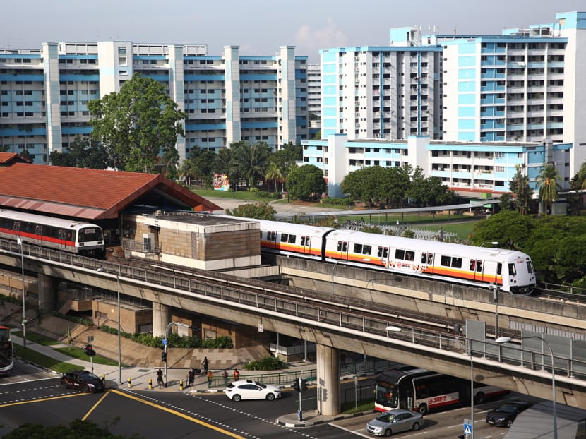 The new SMRT train (right) pulling out from Yishun MRT station on its first day of passenger service yesterday. Tech and other upgrades in the new trains are expected to improve the commuting experience. Photo: Nuria Ling