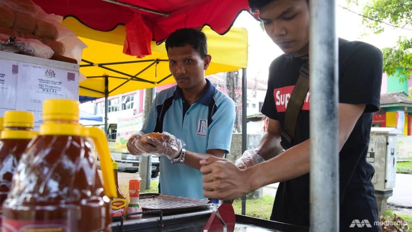 Deaf burger sellers in Malaysia overcome the odds to stand on their own feet