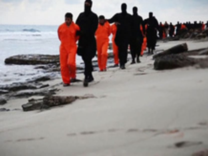 Men in orange jumpsuits, purported to be Egyptian Christians held captive by the Islamic State, are marched along a beach said to be near Tripoli. Photo: Reuters