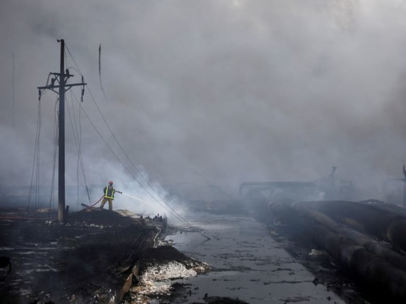 FILE PHOTO: A firefighter works on the zone where fuel storage tanks exploded near Cuba's supertanker port in Matanzas, Cuba, August 9, 2022. REUTERS/Alexandre Meneghini    