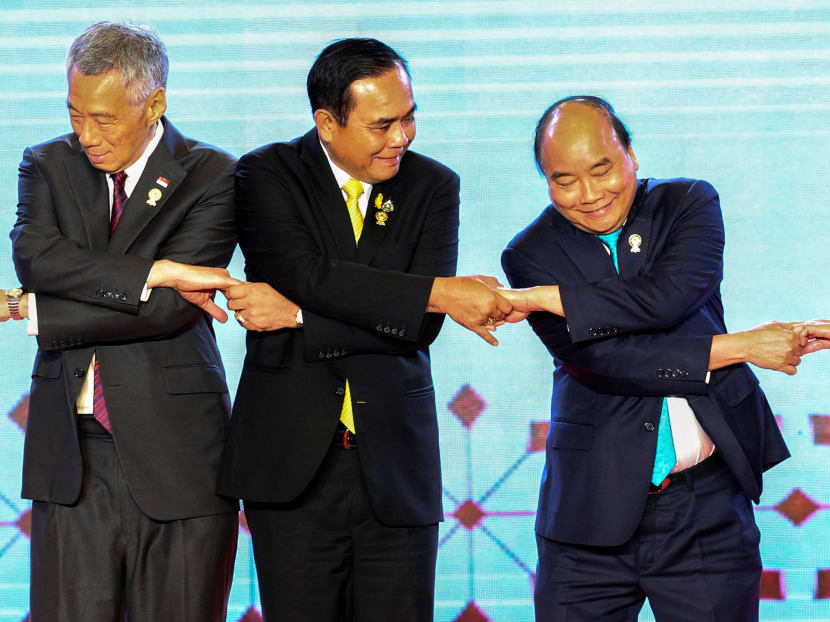 (From left) Singapore's Prime Minister Lee Hsien Loong, Thai Prime Minister Prayuth Chan-ocha and Vietnam's Prime Minister Nguyen Xuan Phuc shake hands on stage during the opening ceremony of the 34th Asean Summit at the Athenee Hotel in Bangkok, Thailand, June 23, 2019.