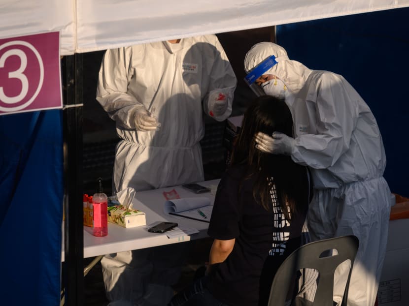 A health worker administers a swab at a temporary Covid-19 novel coronavirus testing centre in Bucheon, south of Seoul, on May 28, 2020.