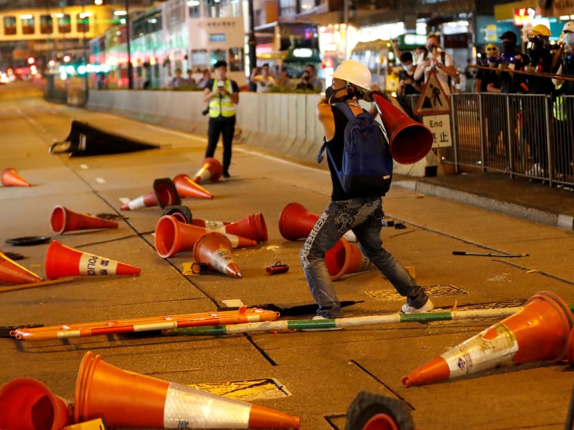 Photo of the day: A demonstrator throws a traffic cone at a group of people opposing the anti-government protesters, during a demonstration in support of the city-wide strike and to call for democratic reforms in Hong Kong, China, August 5, 2019.