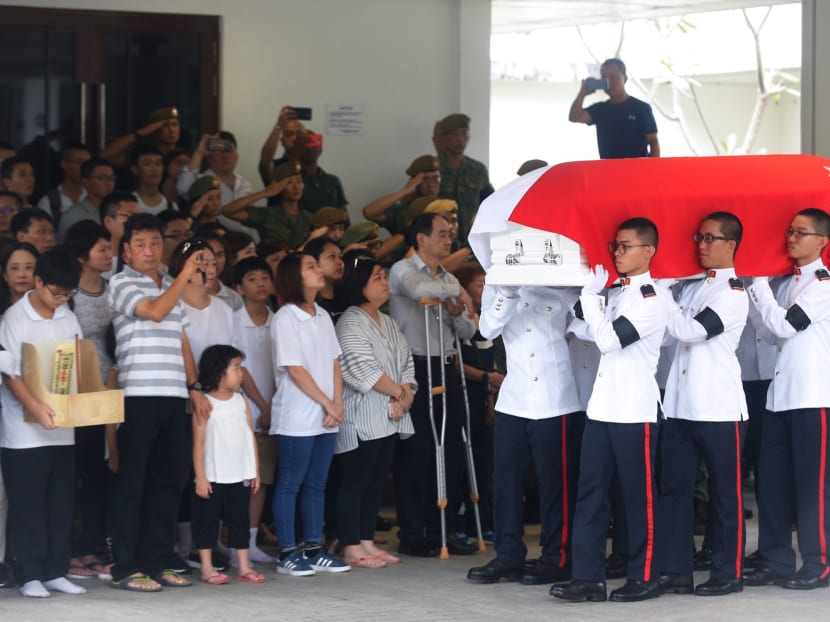 Soldiers carrying the coffin of full-time national serviceman Dave Lee Han Xuan into the hall at Mandai Crematorium on Saturday (May 5) during his military funeral.