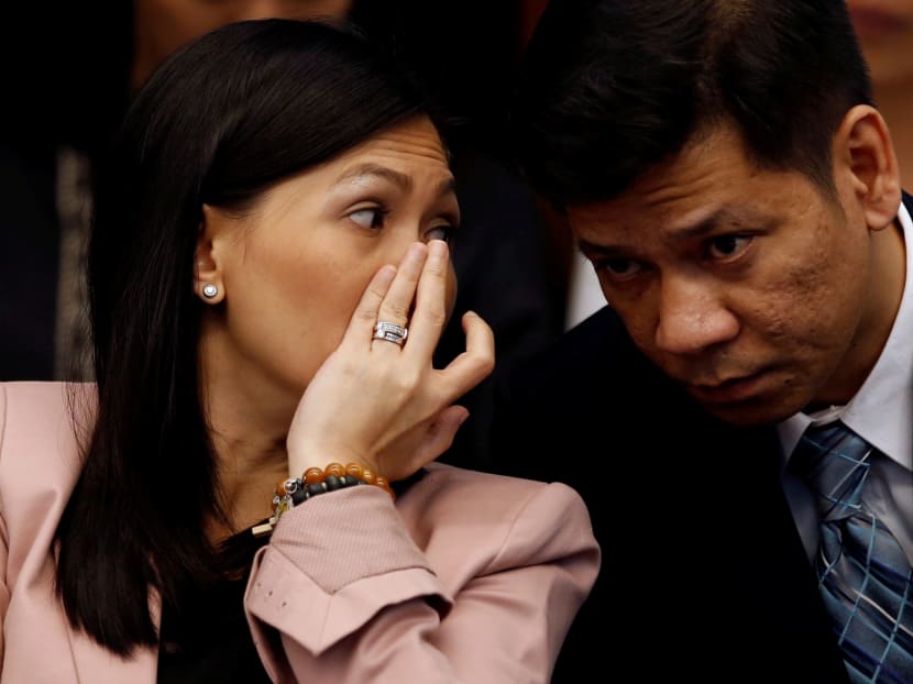 Maia Santos Deguito, a branch manager of the Rizal Commercial Banking Corp, whispers to her lawyer as she testifies during a Senate hearing in Manila in April 12, 2016. Photo: Reuters