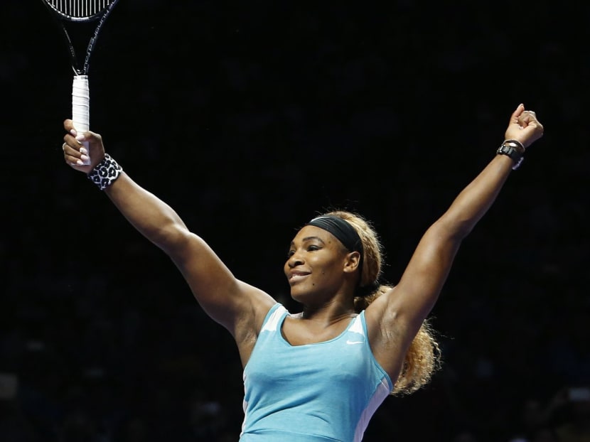 Serena Williams of the United States celebrates defeating Simona Halep of Romania in the women's singles final tennis match of the WTA Finals at the Singapore Indoor Stadium October 26, 2014. Photo: Reuters