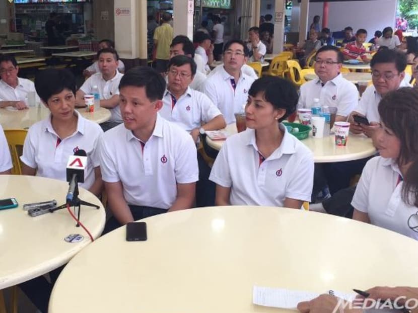 Tanjong Pagar GRC MP Chan Chun Sing (centre) briefs the media during his team's walkabout on Sunday morning. Photo: Imelda Saad