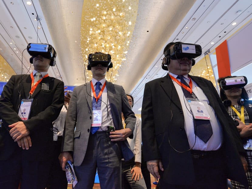Participants trying out virtual reality for use in educational application at the Infocomm Media Business Exchange 2017, on May 23, 2017. Photo: Robin Choo/TODAY