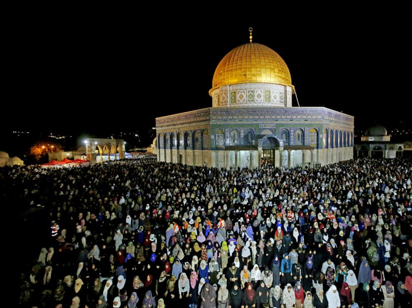 Muslim worshippers praying late on Saturday outside the Dome of the Rock in Jerusalem in observance of Lailat al Qadr, or Night of Destiny, which is a part of Ramadan.  For the vast majority of the world’s Muslims, violence is completely dissonant with the holy month. PHOTO: AFP