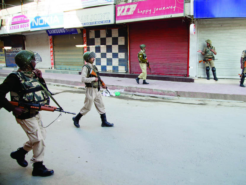 Indian paramilitary forces patrolling a closed market area in Srinagar yesterday. Photo: AP