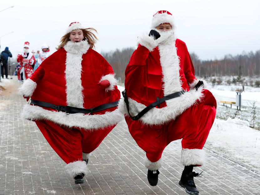 Photo of the day: Belarusians dressed as Santa Clauses and other Christmas characters take part in the country's first Santa Run around a lake in Minsk, Belarus.