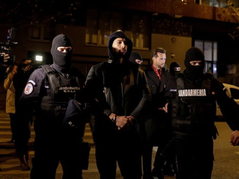 Andrew Tate and Tristan Tate are escorted by police officers outside the headquarters of the Directorate for Investigating organised crime and Terrorism in Bucharest after being detained for 24 hours, in Bucharest, Romania, Dec 29, 2022. 