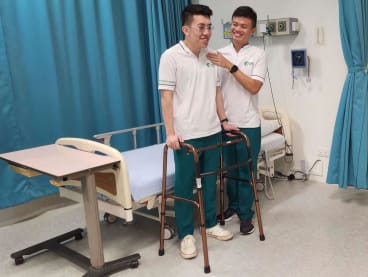 The author (right) demonstrating the proper way to assist a patient as part of his training under HMI Institute.