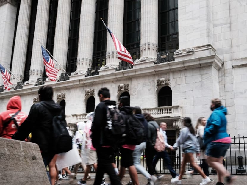 People walk by the New York Stock Exchange on June 16, 2022 in New York City, a day after the Federal Reserve's largest rate hike since 1994.