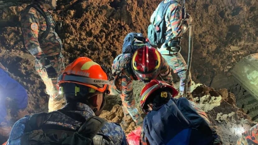 Body of man hugging dog recovered as Malaysia landslide death toll rises to 26