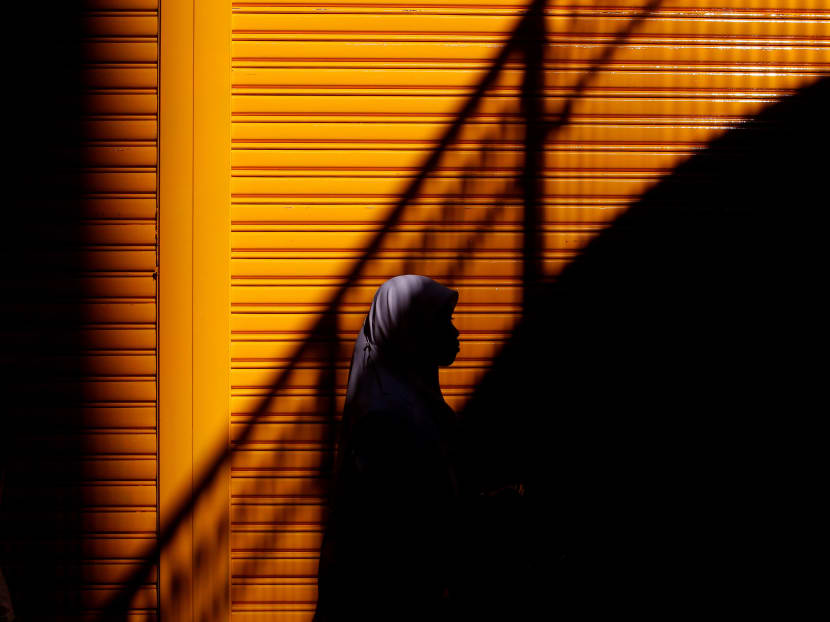 This file photo taken on August 7, 2011 shows an Indonesian woman walking along a street in the Causeway Bay district of Hong Kong on a Sunday when most of the city's domestic helpers get the day off. Photo: AFP