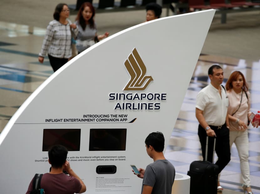 People pass a Singapore Airlines signage at Changi Airport in Singapore May 11, 2016. Photo: Reuters
