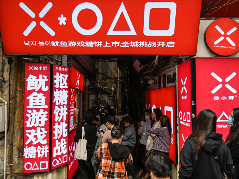 Customers waiting at a small shop for dalgonas, a crisp sugar candy featured in the Netflix series Squid Game, in Shanghai, on Oct 12, 2021.