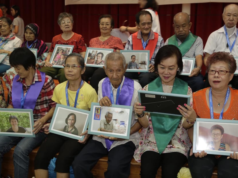 Elderly from Care Community Services Society posing with their portrait photographs at Project Wish on Dec 1, 2016. Photo: Wee Teck Hian