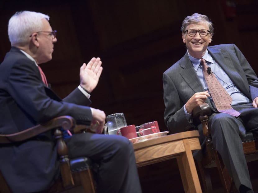 Microsoft founder and philanthropist Bill Gates, right, talks with David Rubenstein, left, co-chairman of Harvard's capital campaign, during the campaign launch at the  Sanders Theatre on campus at Harvard Saturday, Sept. 21, 2013, in Cambridge, Mass. Photo: AP