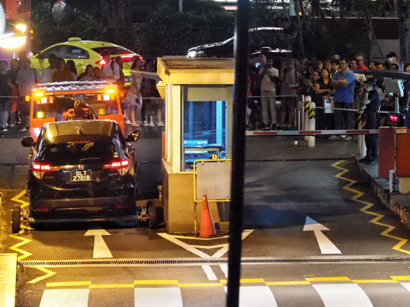 A crowd watching the car involved in Sunday's fatal accident at Lucky Plaza being towed away. Two female pedestrians were killed and four others were injured. A crowd watching the car involved in Sunday's fatal accident at Lucky Plaza being towed away. Two female pedestrians were killed and four others were injured.