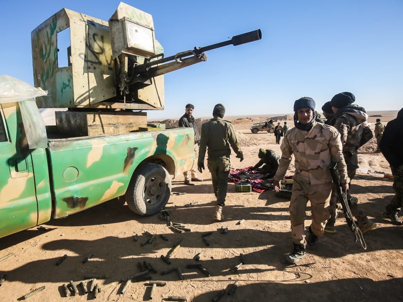 Fighters of the Hashed al-Shaabi (Popular Mobilisation) paramilitaries prepare defensive positions near the frontline village of Ayn al-Hisan, on the outskirts of Tal Afar west of Mosul, where Iraqi forces are preparing for the offensive retake the western side of Mosul from Islamic State (IS) group fighters. Photo: AFP.