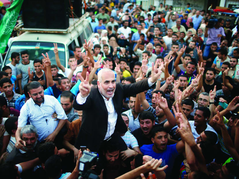 Palestinians carrying Hamas spokesman Fawzi Barhoum (centre) as they celebrate what they said was a victory over Israel following a ceasefire in Gaza City in August. Photo: Reuters