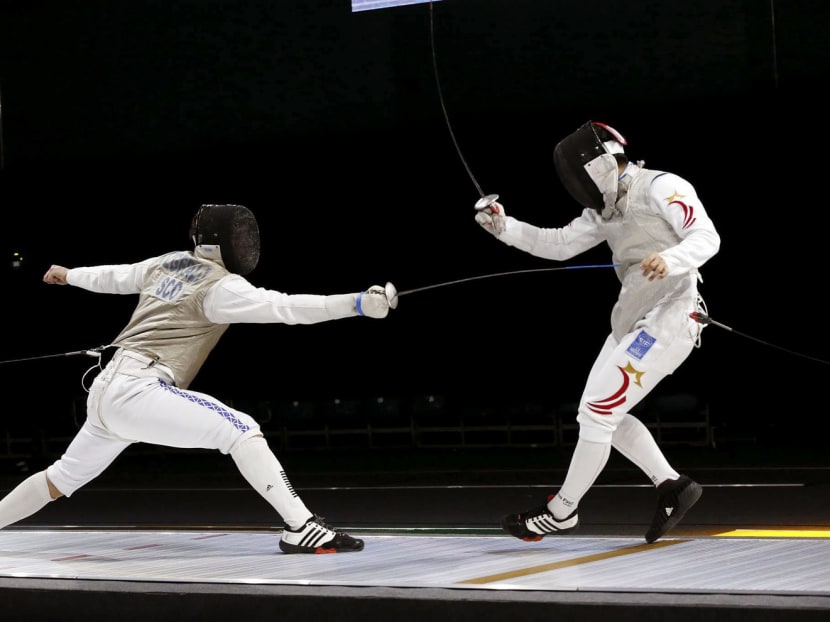 Singapore’s Zhang Zhenggang (right) in action against Scotland’s Jamie Fitzgerald yesterday. Photo: International Fencing Federation