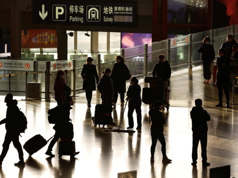 Travellers enter a terminal hall, during the annual Spring Festival travel rush ahead of the Chinese Lunar New Year in Beijing Capital International Airport on Jan 18, 2023. 
