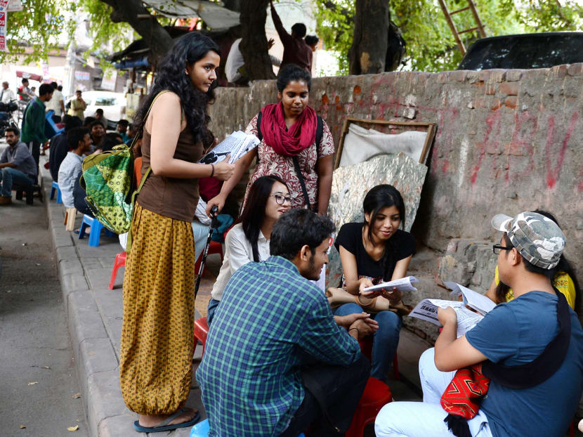 Activists Shambhawi Vikkam (left) and Shriya Subhashini (middle) speaking to fellow students outside Delhi University about the Pinjra Tod campaign, protesting how universities force women to return to their dorms early. PHOTO: AFP