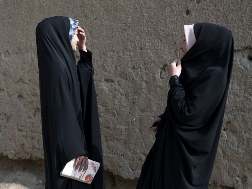 Afghan Hazara girls gesture along a street in Dasht-e-Barchi in Kabul on Nov 7, 2022. Afghan Hazara girls gesture along a street in Dasht-e-Barchi in Kabul on Nov 7, 2022.