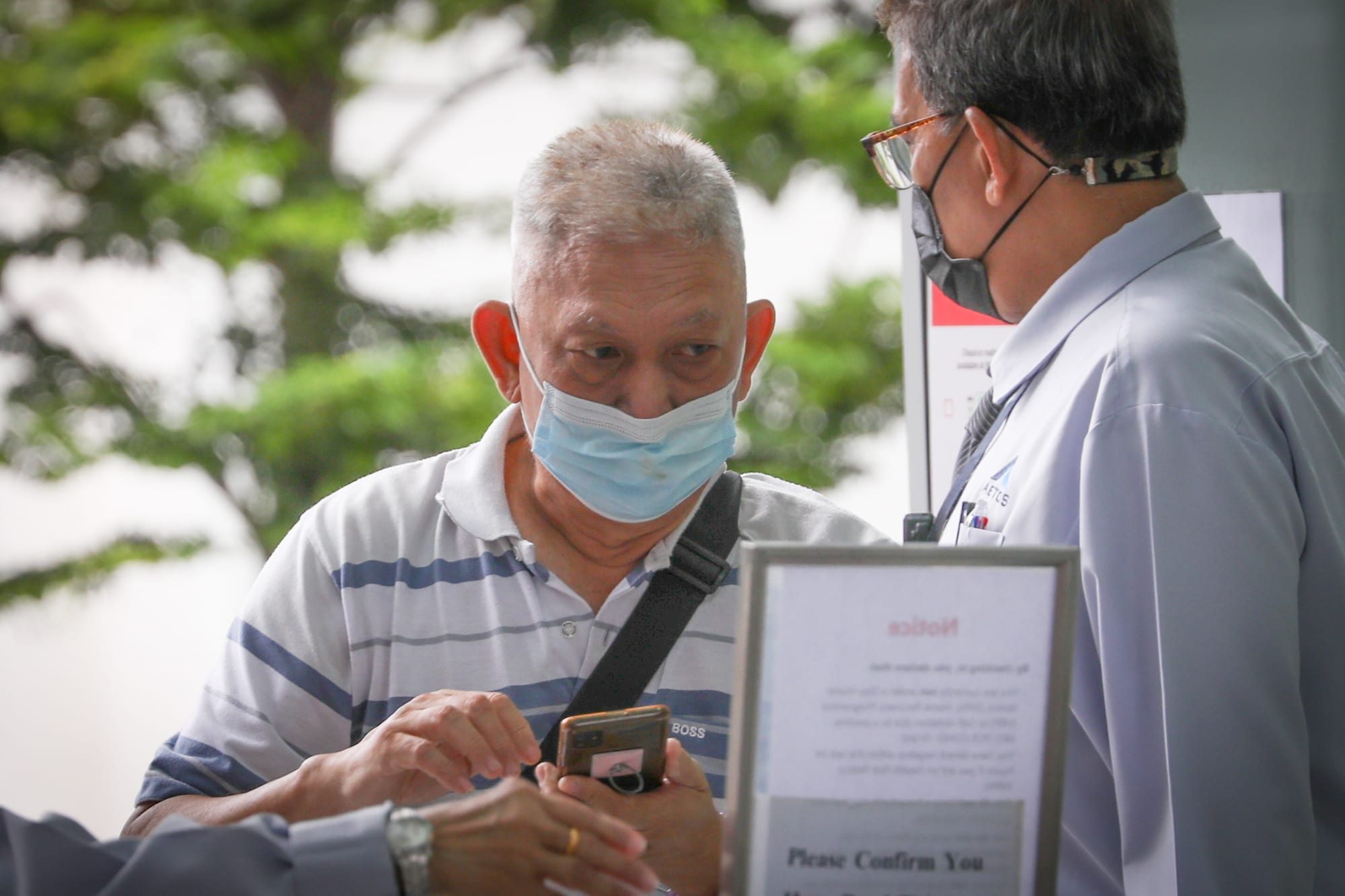 Tan Hwee Koon (left) outside the State Courts on March 10, 2022. Tan Hwee Koon (left) outside the State Courts on March 10, 2022.