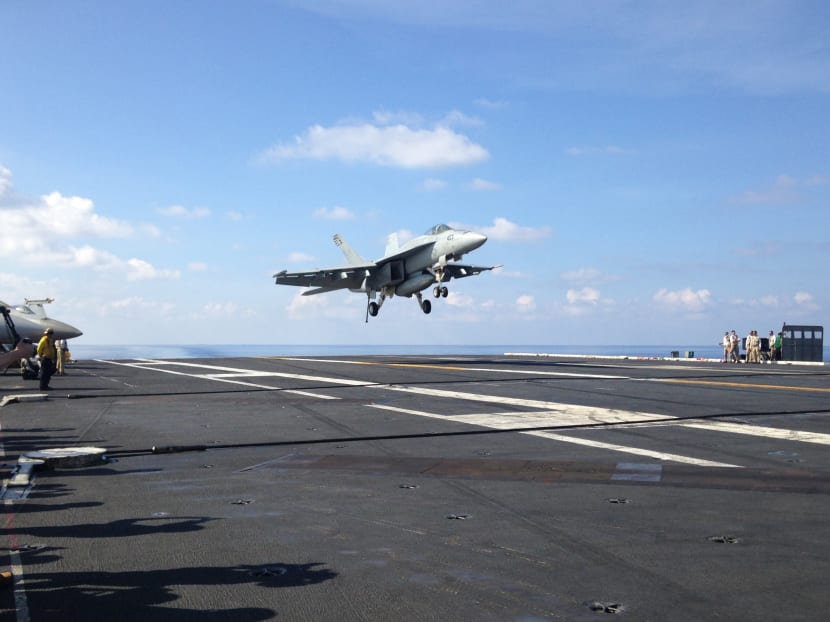 An FA-18 jet fighter lands on the USS John C. Stennis, an aircraft carrier in the South China Sea. Photo: AP