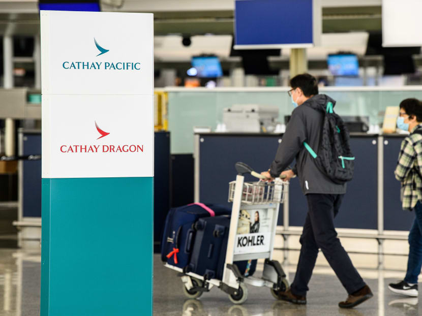 Passengers walking near Cathay Pacific check-in counters at Hong Kong International Airport on Oct 20, 2020.