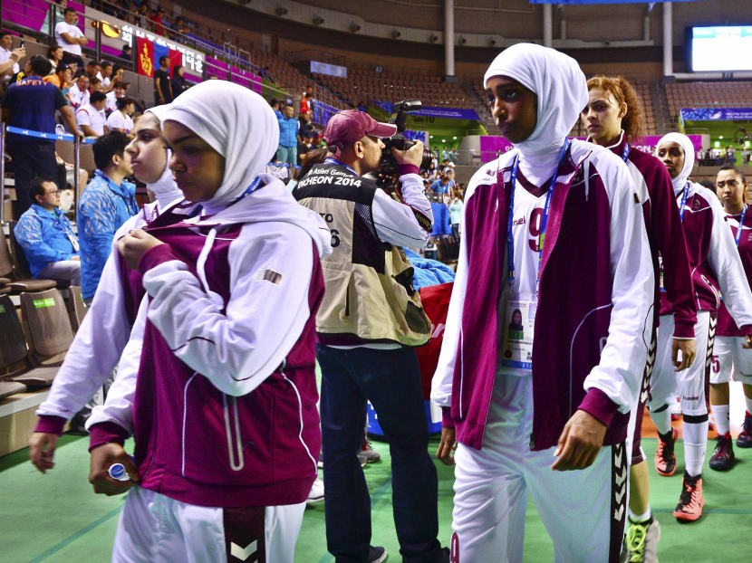 Qatar's women's basketball team leaves the court after forfeiting their women's basketball game against Mongolia at Hwaseong Sports Complex during the 17th Asian Games in Incheon Sept 24, 2014. Photo: Reuters/Sports Chosun