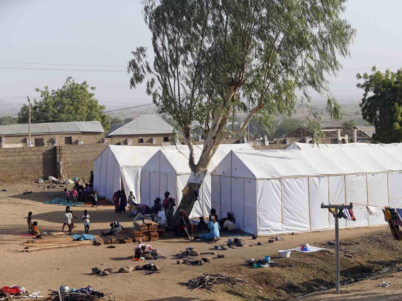 People displaced as a result of Boko Haram attacks in the northeast region of Nigeria, are seen near their tents at a faith-based camp for internally displaced people (IDP) in Yola, Adamawa State Jan 14, 2015. Photo: Reuters