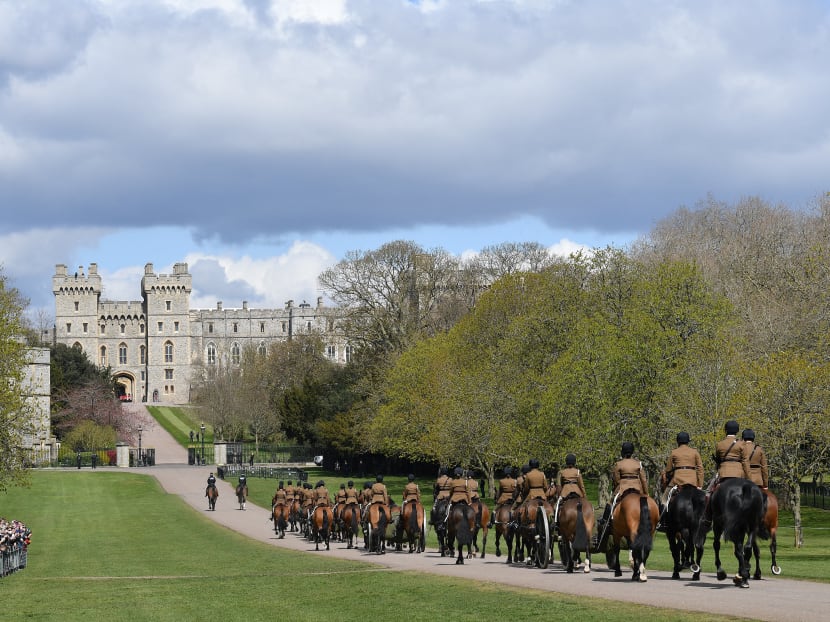 Members of the Kings Troop Royal Horse Artillery ride their horses into the grounds of Windsor Castle in Windsor, west of London on April 15, 2021 following the April 9 death of Britain's Prince Philip, Duke of Edinburgh.