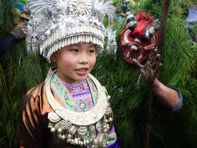 Photo of the day: An ethnic Miao woman poses with ethnic Miao men dressed as "Manghao" during an event to celebrate the Manghao Festival at Rongshui Miao Autonomous County, in Liuzhou, Guangxi Zhuang Autonomous Region, China.