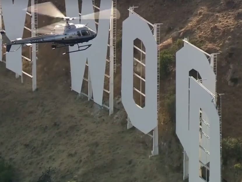 A screenshot of Fox 11 Los Angeles' video of a man identified as Vitaly Zdorovetskiy climbing the Hollywood sign.