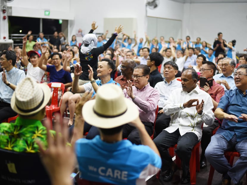 Minister K Shanmugam (second from right, in white) enjoying a percussion performance by the residents of All Saints Home (Yishun). Photo: All Saints Home